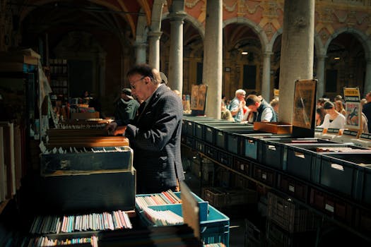 A bustling vintage market in Lille, France with people browsing through records and books.