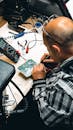 Man working on electronics circuit board at desk