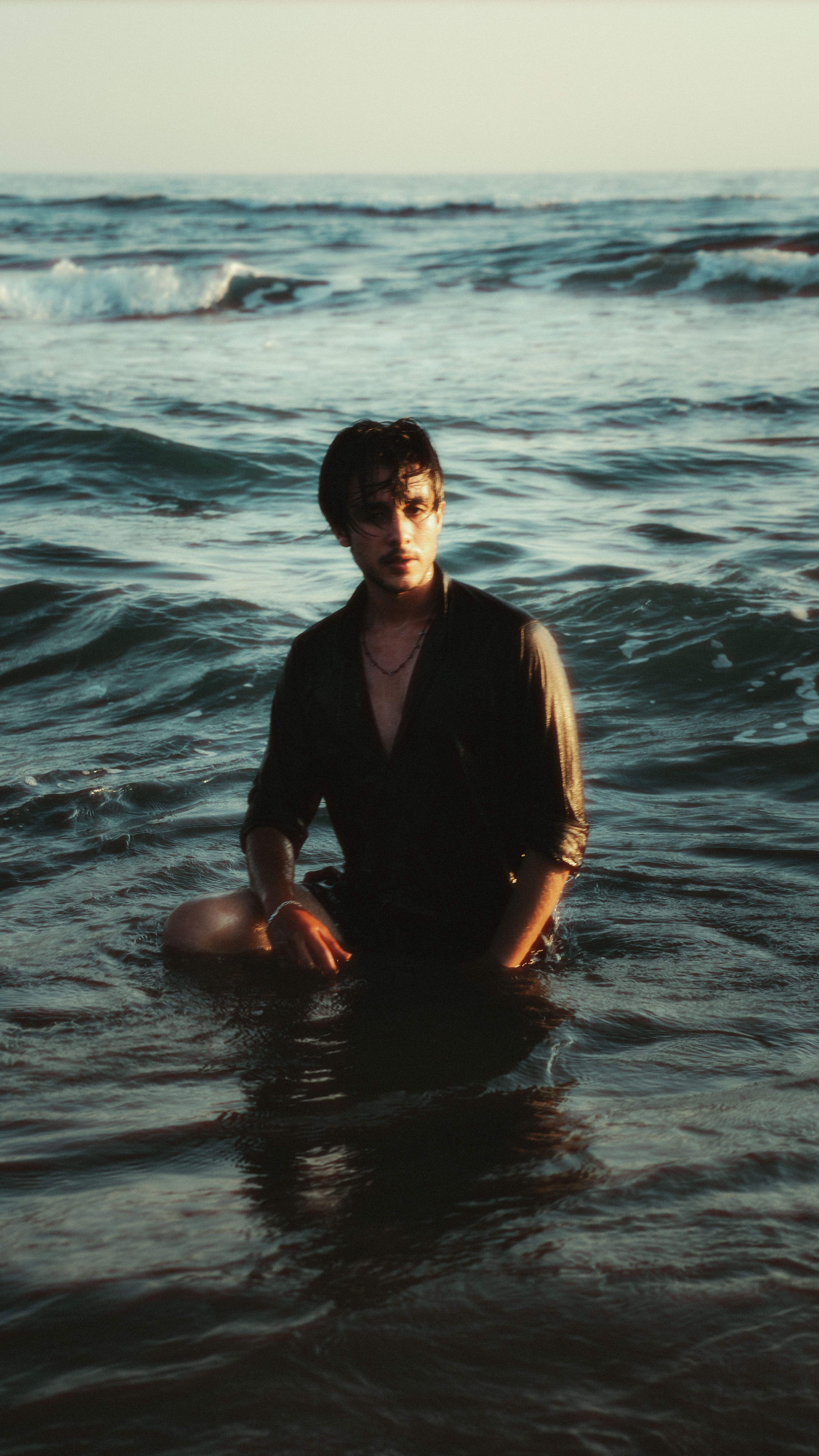 Moody Portrait of Man in Ocean at Sunset · Free Stock Photo