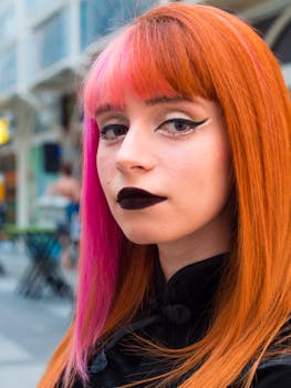 Colorful street portrait of a woman with vibrant hair and bold makeup.
