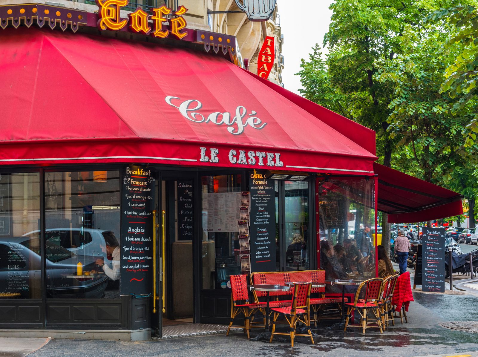 A Parisian street with cafes and morning light