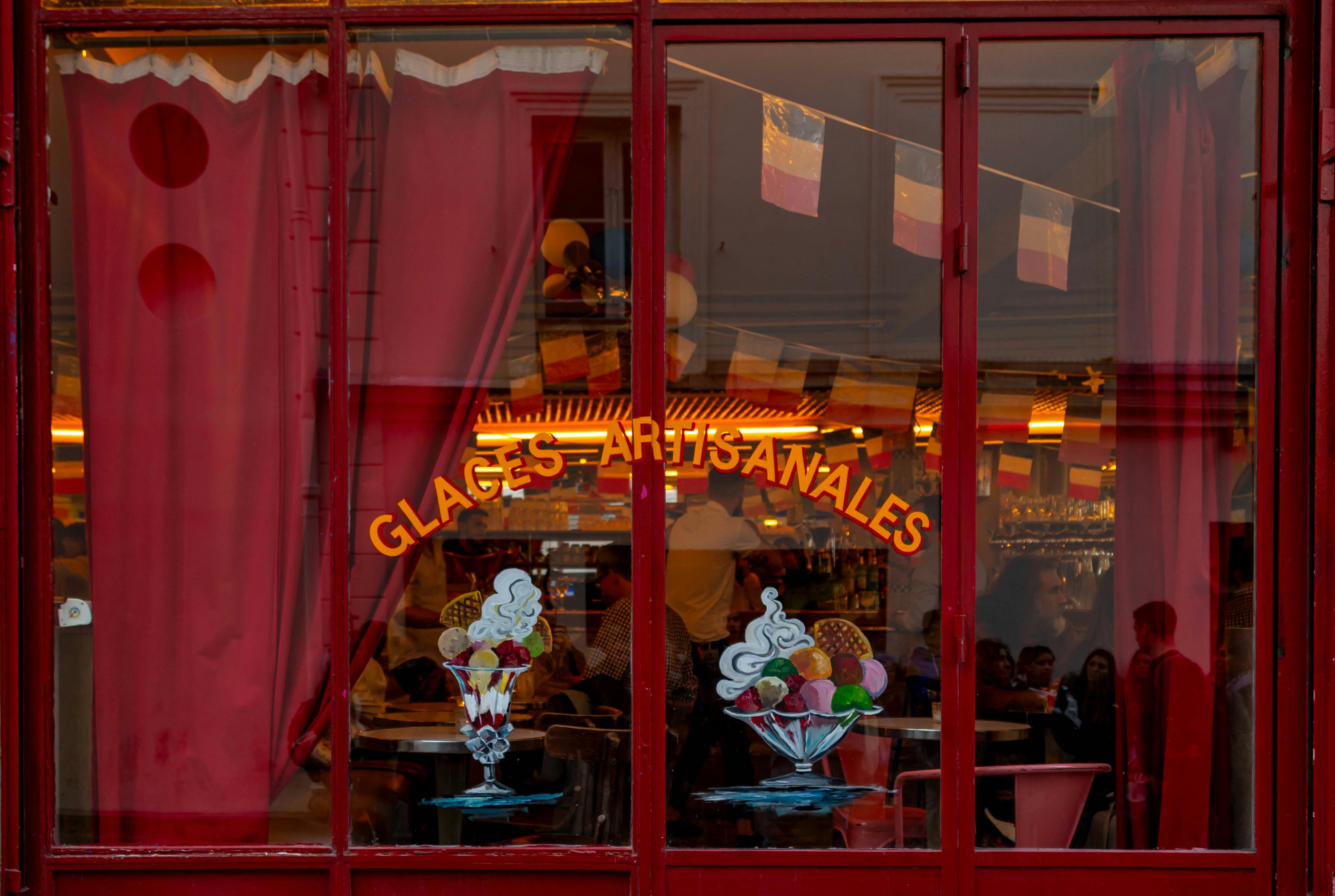 Charming view inside a Parisian ice cream parlor with colorful decor and lively atmosphere.