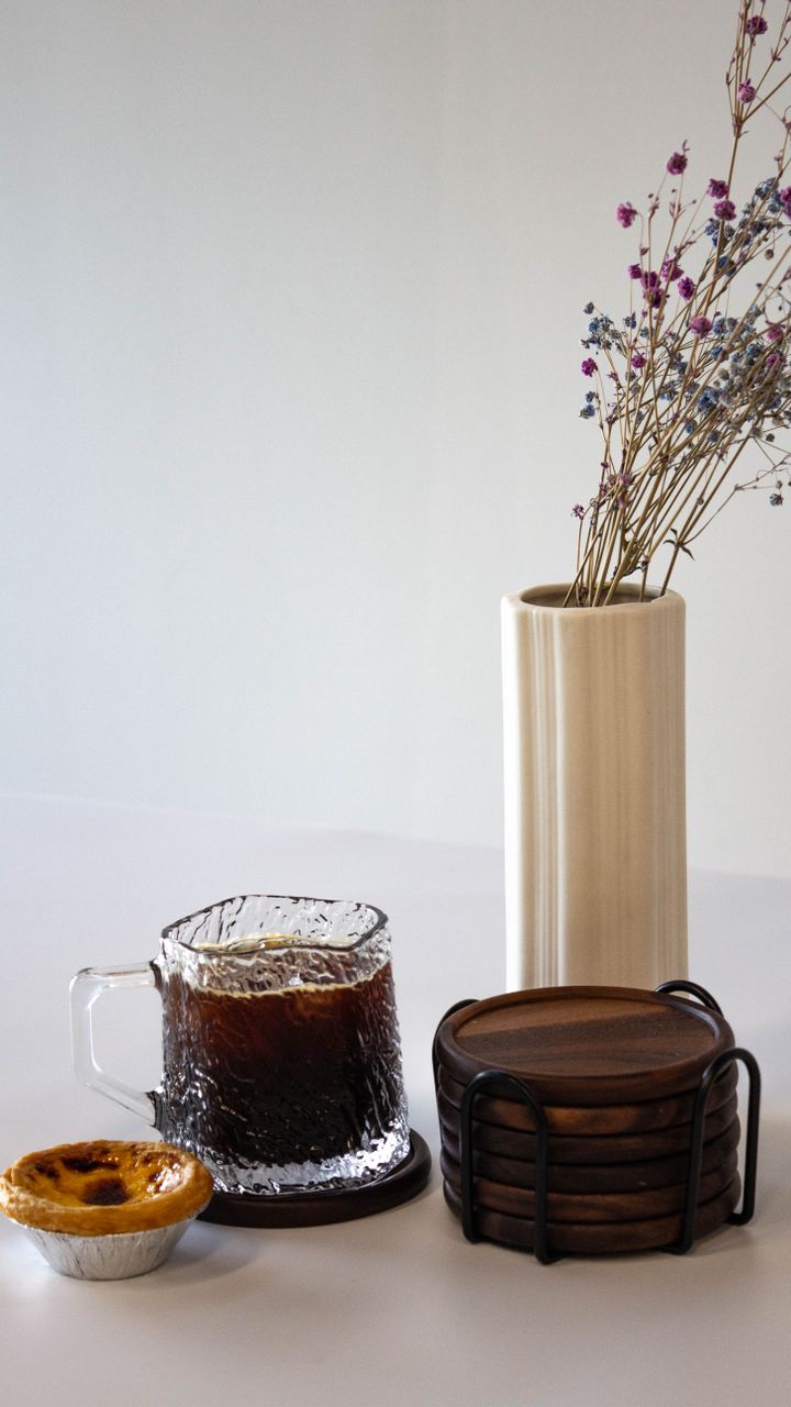 Set of acacia wooden coasters stacked on a coffee bar hutch shelf