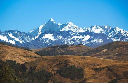 Free Breathtaking view of the snow-capped Andes mountains in Cuzco, Peru under a clear blue sky. Stock Photo