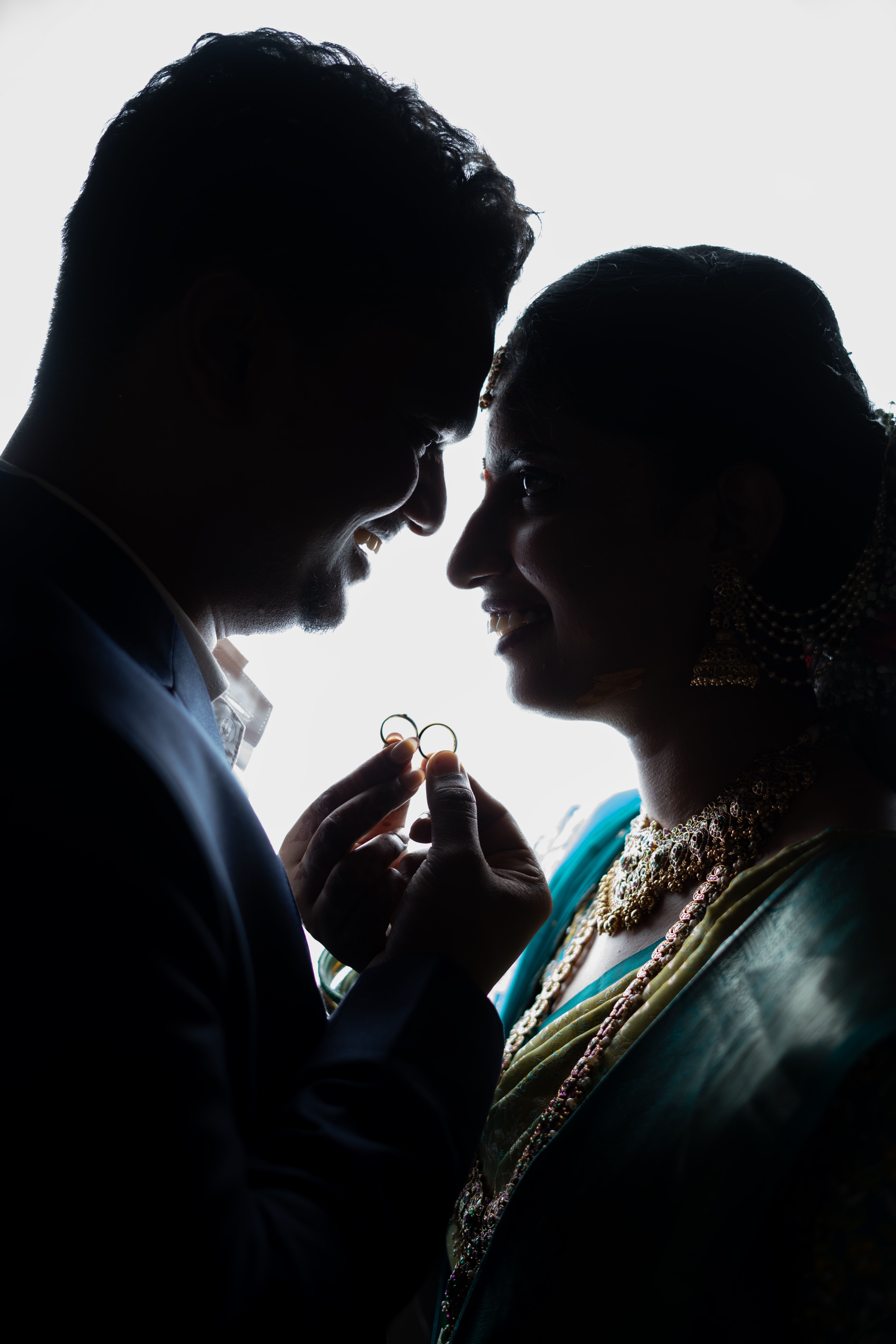Stunning silhouette of an Indian couple exchanging rings, highlighting love and tradition.