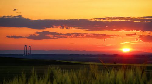 Free Captivating sunset over Brăila, Romania featuring a prominent bridge and vibrant sky. Stock Photo