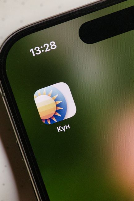 A professional checking a smartphone weather app for optimizing daily routines to avoid unnecessary expenses.
