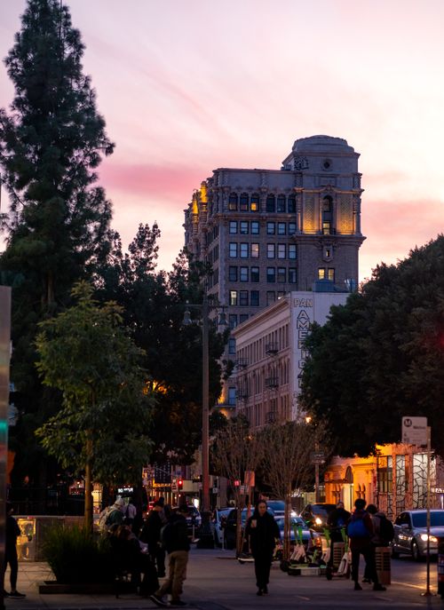 Free City street at twilight with historic architecture and vibrant sky. Stock Photo