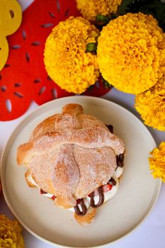 Pan de Muerto with marigolds, a Day of the Dead tradition in Mexico.
