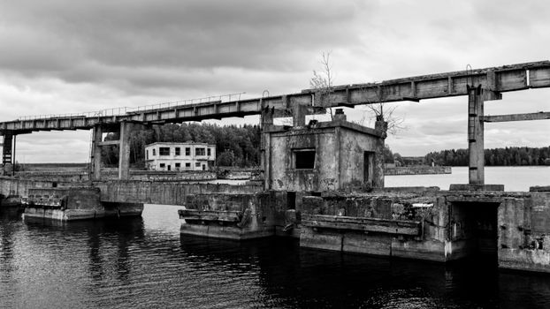 Monochrome view of the abandoned Hara submarine base in Estonia, showcasing decayed structures.