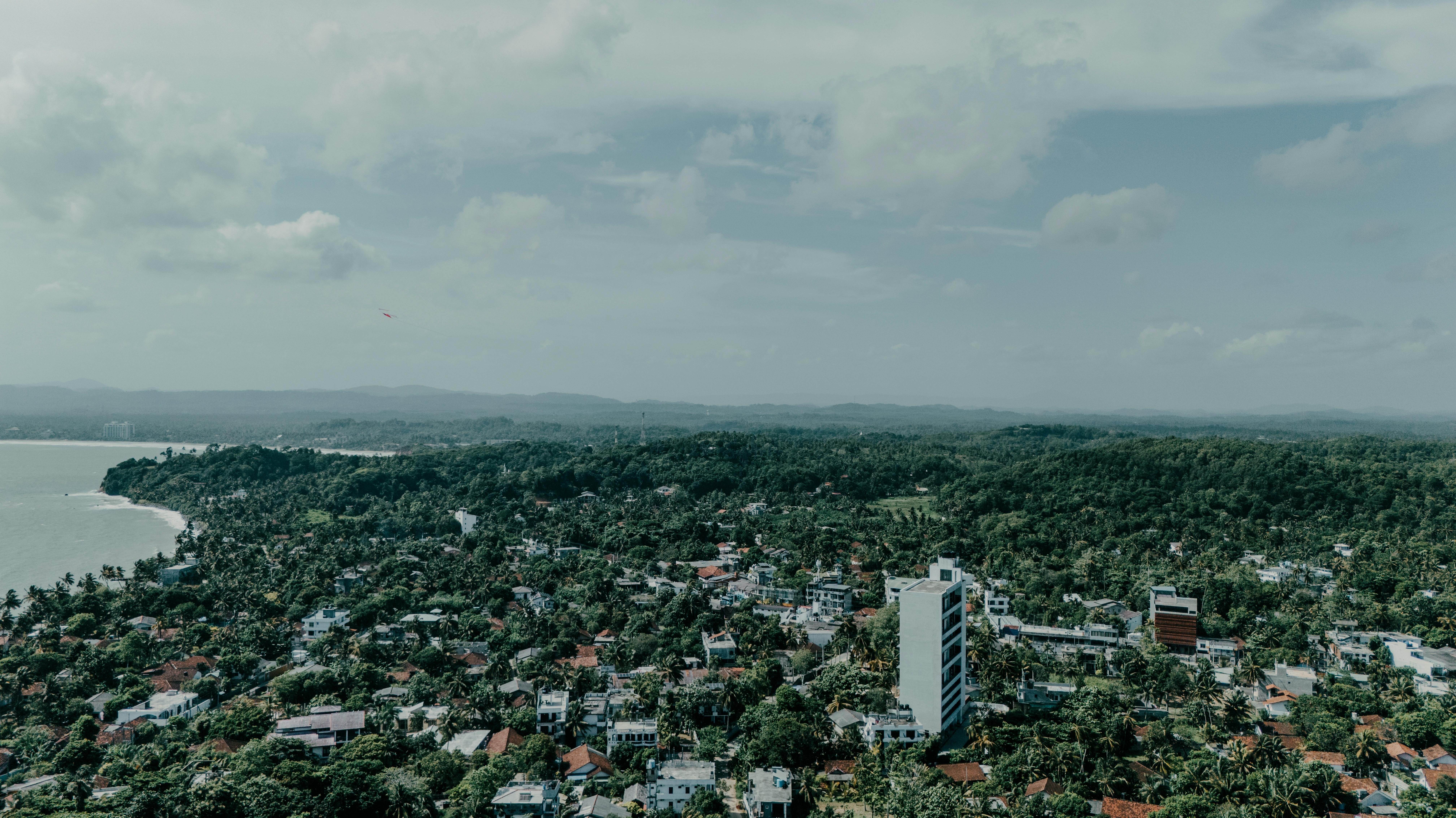 Desert eco hotel with earth-toned buildings and sustainable water features under blue sky