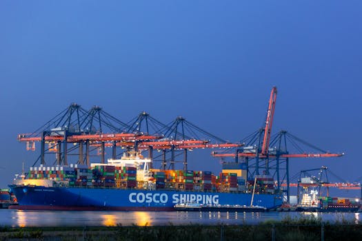 A COSCO shipping cargo vessel docked at Maasvlakte port, illuminated against the night sky in Rotterdam.