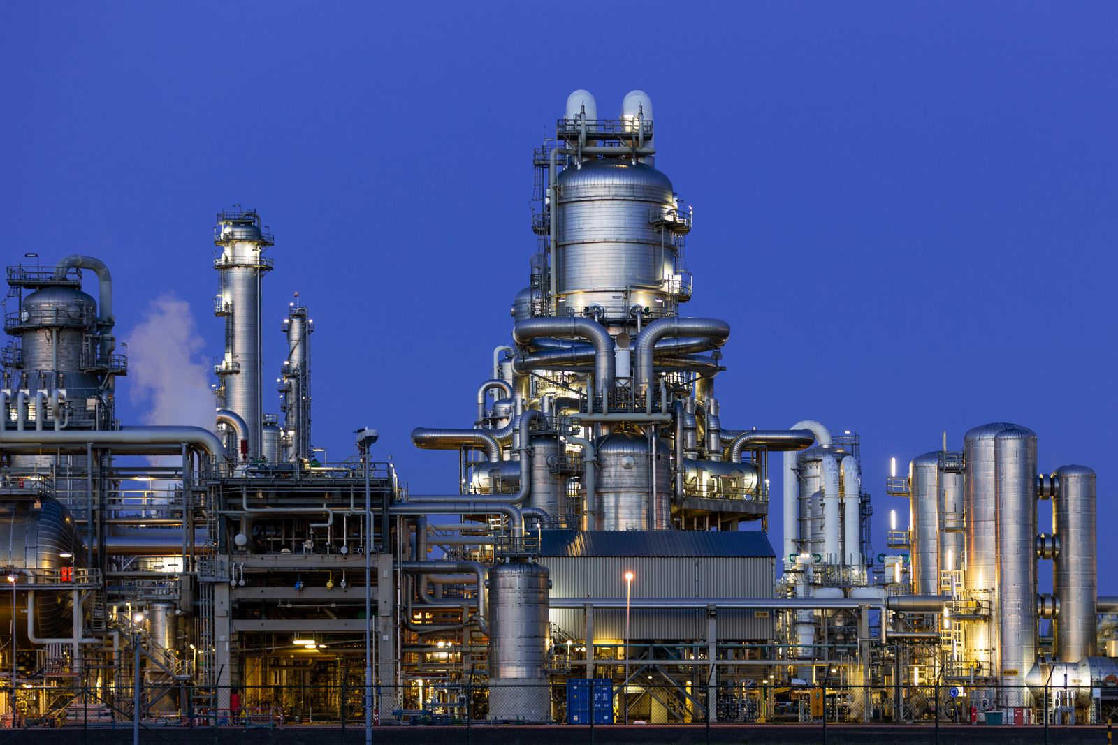 Industrial refinery and chemical process plant illuminated at twilight