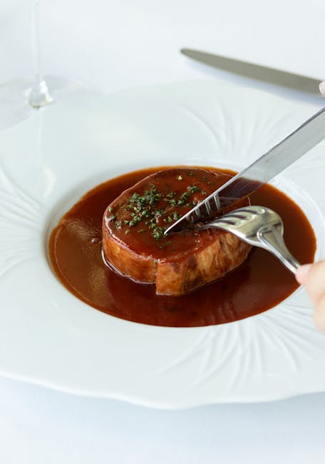 A glossy, deep brown espagnole sauce simmering in a saucepan, thick enough to coat the back of a spoon, with a ladle resting against the rim.