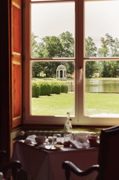 Serene garden view with a gazebo seen from a French restaurant window.