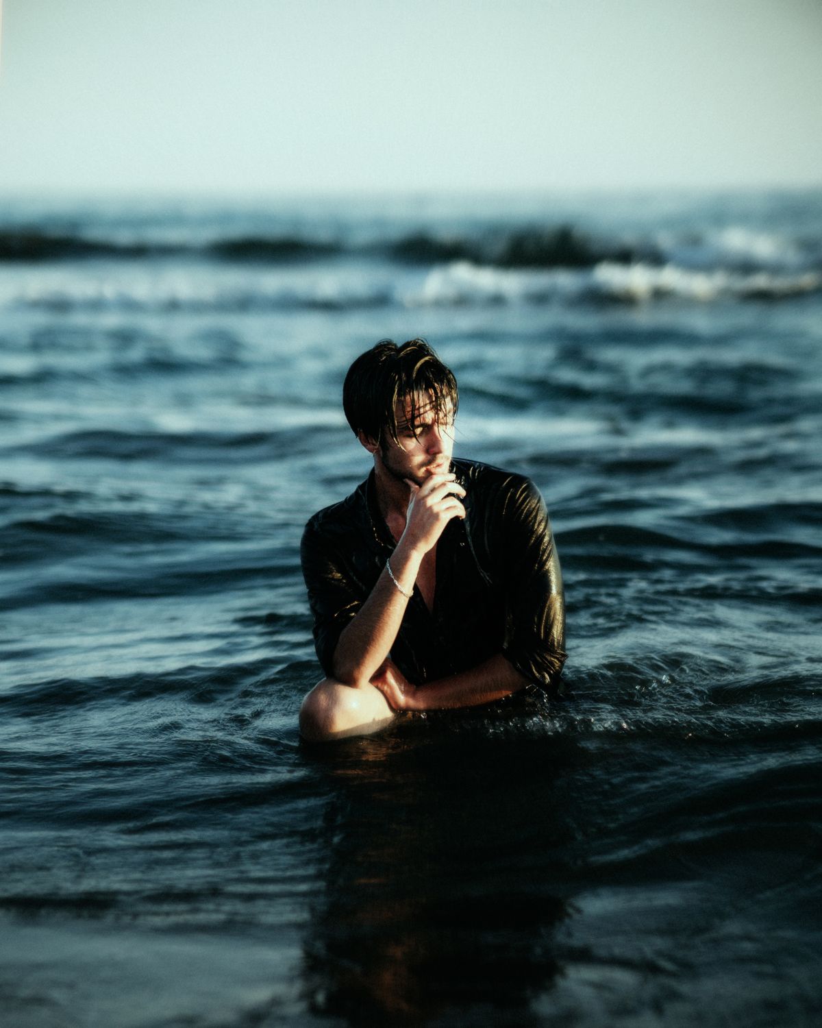Contemplative Man in Ocean at Sunset · Free Stock Photo
