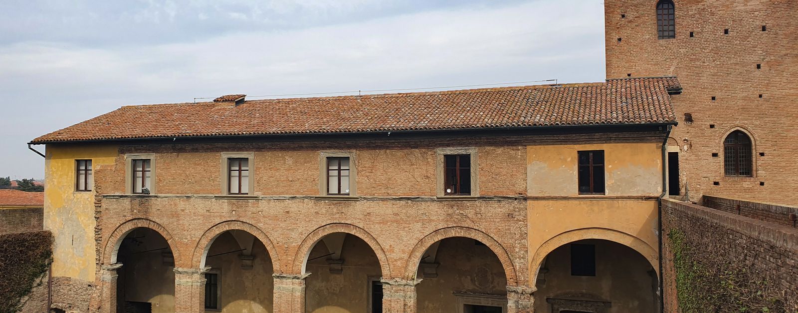 Explore the historic fortress with beautiful arches and brick architecture in Imola, Italy.
