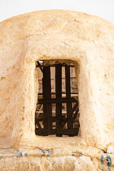 Explore the historic architecture of Tataouine, Tunisia with this unique window design.