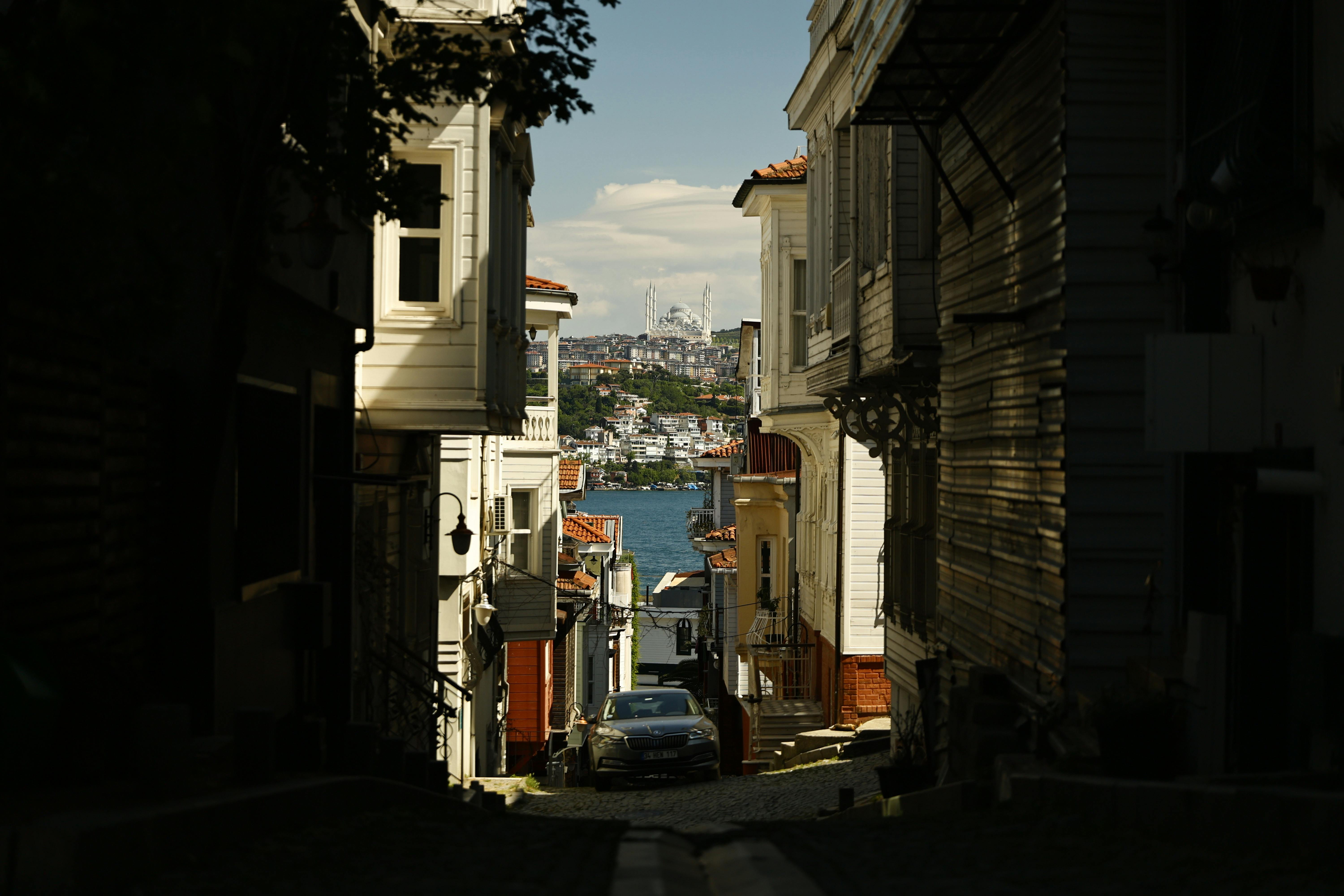 Charming Istanbul street view with Bosphorus and mosque in the background.