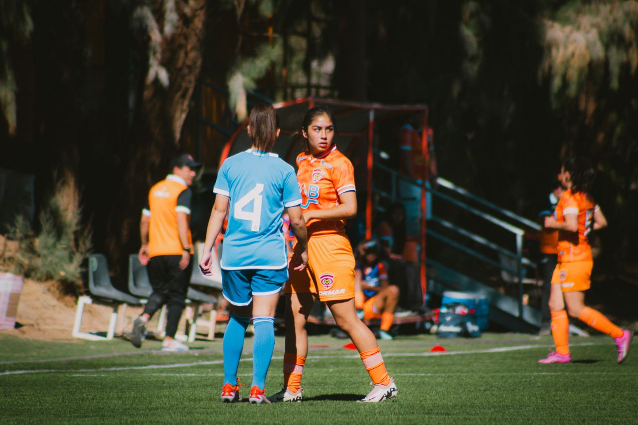 action shot of a women s football match on a sunny day in chile