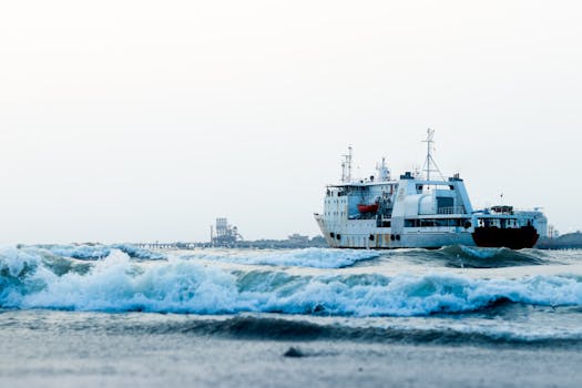 A large ship sails through the waves at Kochi Harbour, Kerala, India.