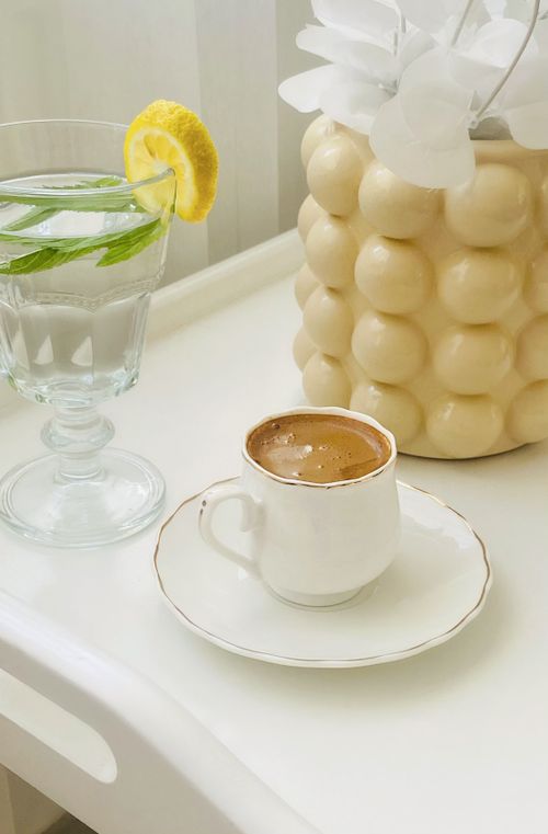Free Stylish setup of coffee and lemon water on a tray with decor vase, perfect for a modern lifestyle. Stock Photo