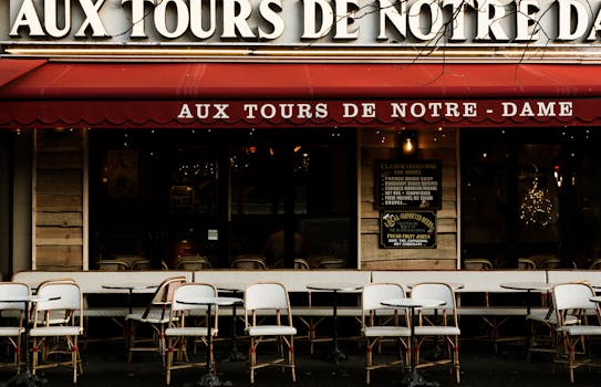 Front view of Aux Tours de Notre Dame cafe in Paris, featuring outdoor seating and iconic French decor.