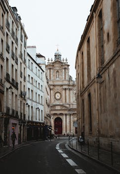 Charming Paris street view leading to a historic church, capturing classic European architecture.