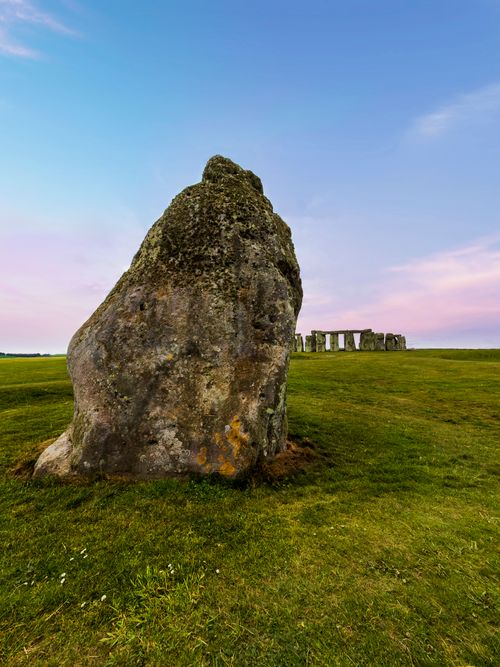 Free Captivating view of Stonehenge under a colorful sunrise sky, showcasing its historical grandeur. Stock Photo