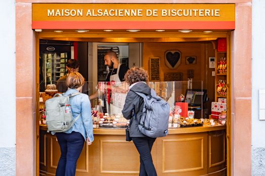 Visitors at Maison Alsacienne de Biscuiterie in Colmar, enjoying local pastries.