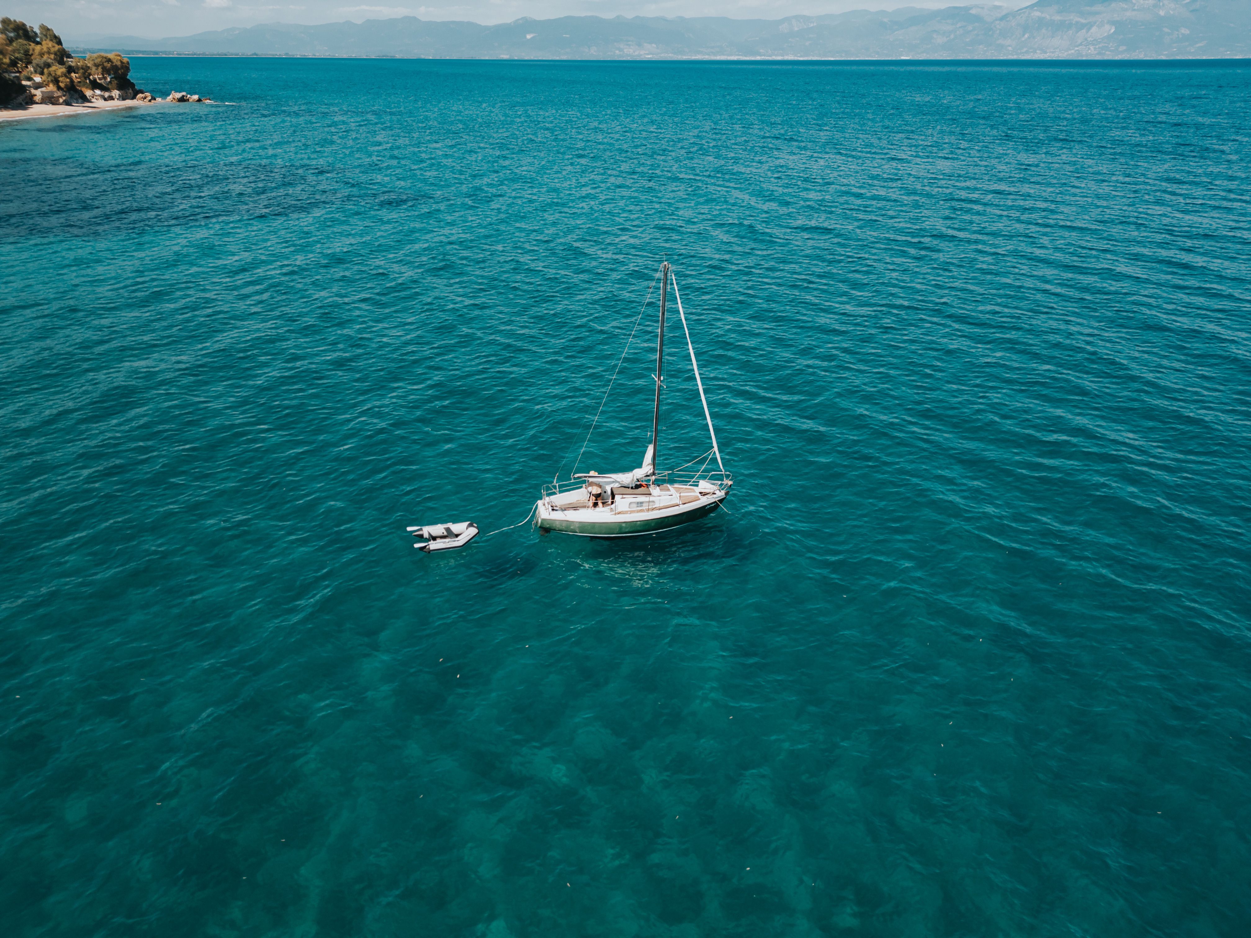 Stunning Full-Day Charter To The Baths Virgin Gorda British Virgin Islands Review 2026 - A peaceful sailboat on clear turquoise waters, perfect for a summer getaway.