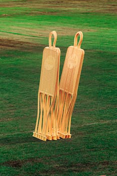 Two orange soccer training mannequins on a lush green field, ideal for coaching setups.