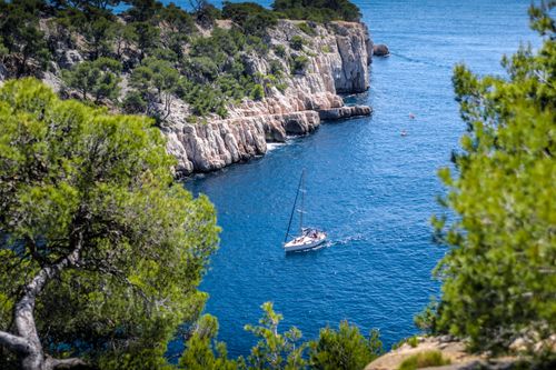 Free Stunning view of a sailboat navigating the blue waters of Calanques National Park near Marseille. Stock Photo