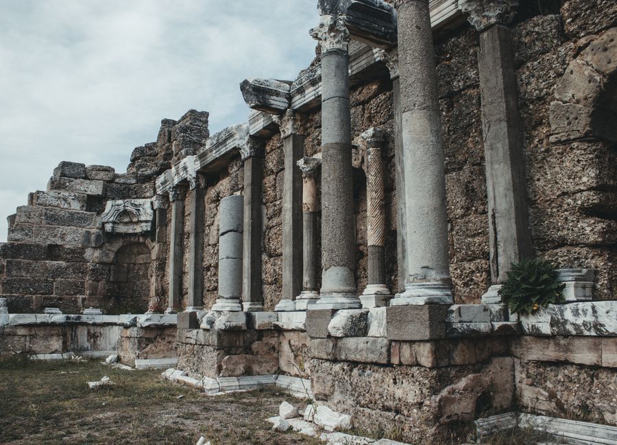Explore the majestic ancient Roman ruins featuring impressive stone columns and intricate carvings.