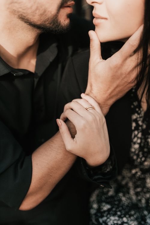 Free Close-up of a loving couple sharing a gentle and intimate moment in soft light. Stock Photo