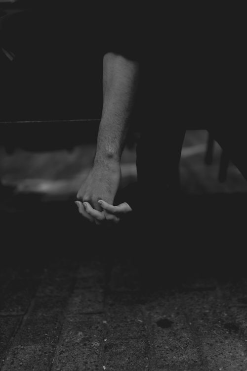 Free A moody black and white photo capturing a person's hands in a contemplative moment. Stock Photo