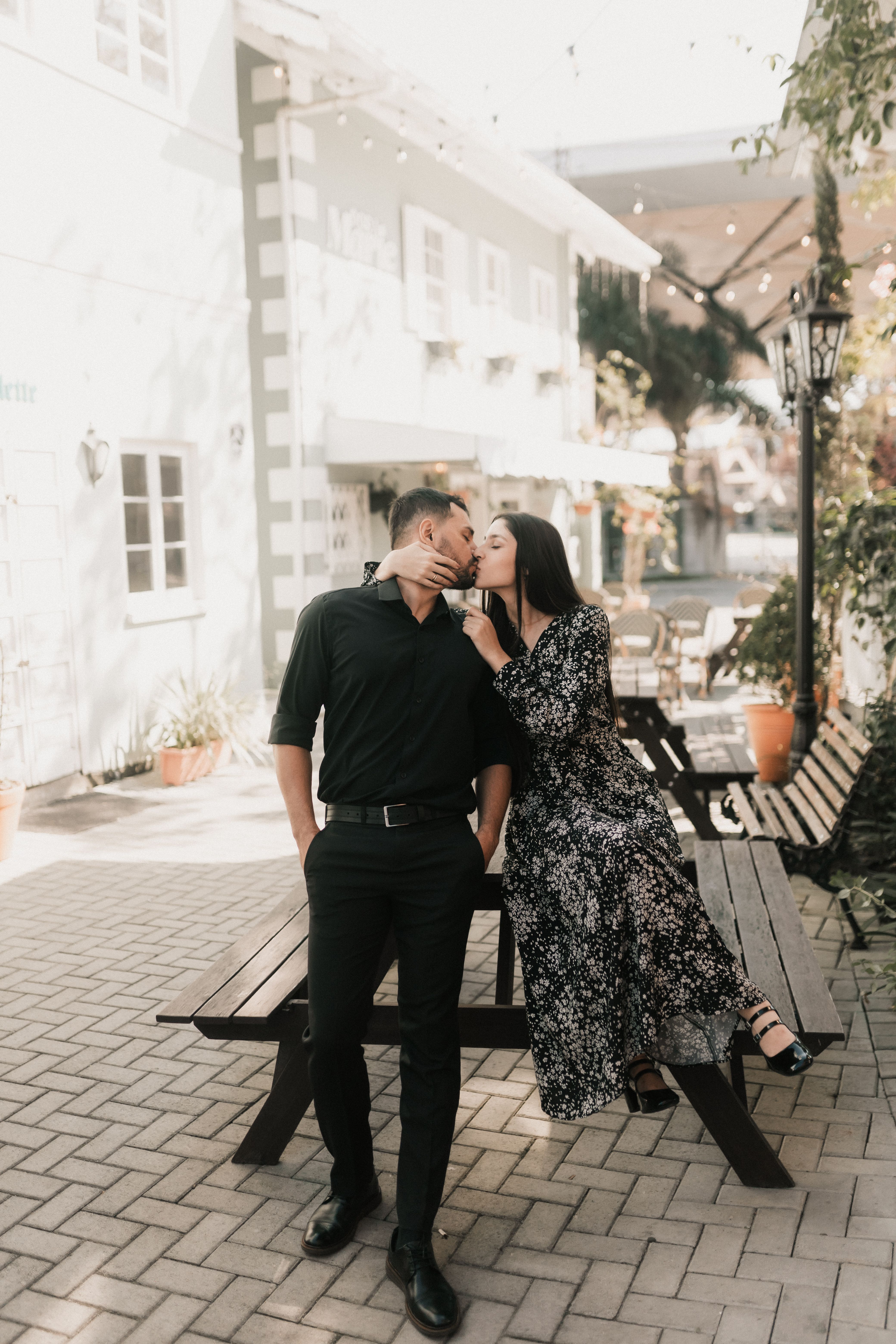Romantic Couple Sharing a Sweet Kiss Outdoors · Free Stock Photo