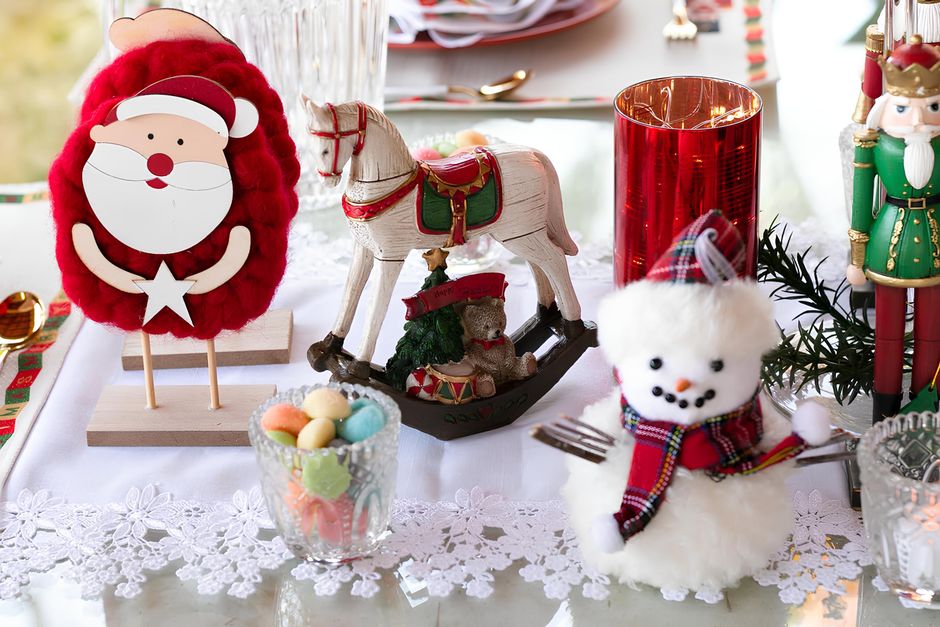 Charming Christmas tabletop with Santa, snowman, and holiday decor.
