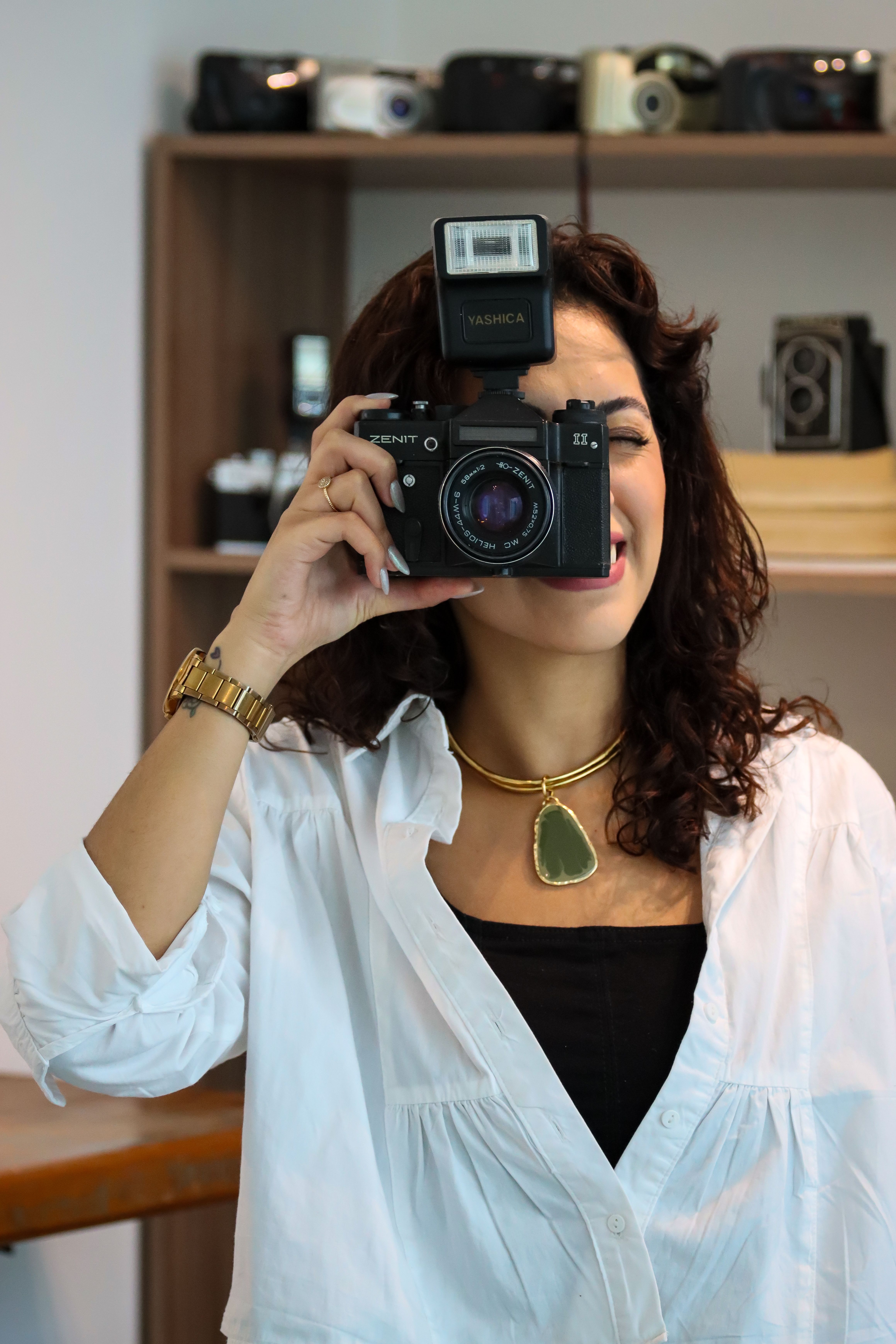 Woman Posing with Retro Camera in Stylish Setting · Free Stock Photo