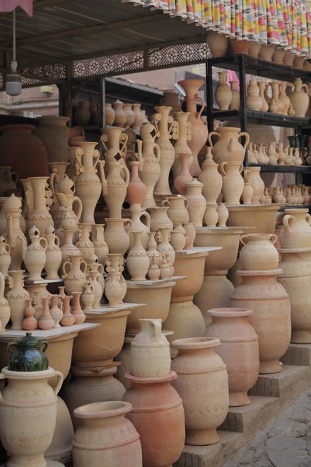 Handcrafted clay pots and vases at an outdoor pottery market — photo by SLEEP SLEEP on Pexels