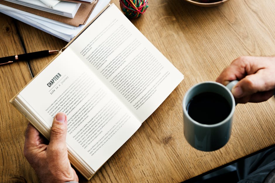 Close-up of Woman Hand With Coffee Cup on Table