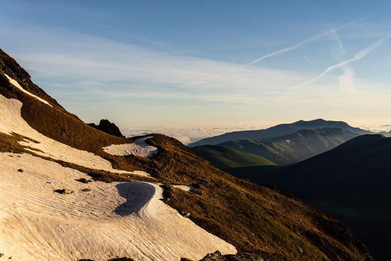 Snowfields on an alpine ridge at sunrise — photo by Joffrey Rouseyrol on Pexels