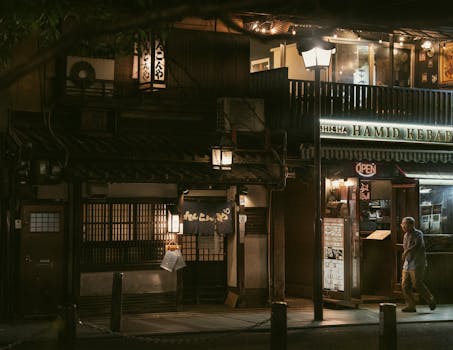 A quiet evening in Kyoto's Gion District featuring traditional architecture and lit shops.