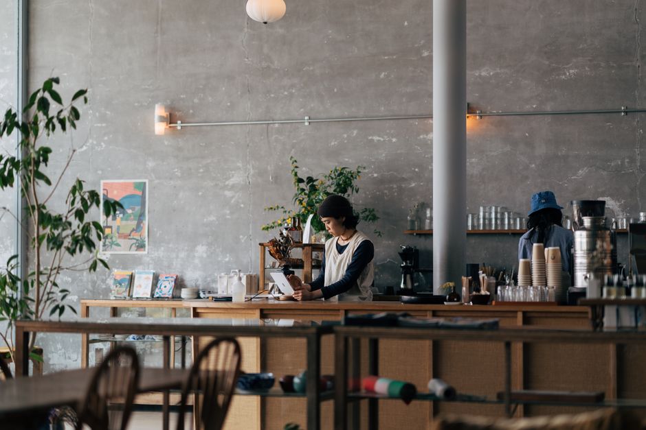 A restaurant owner reviewing financial data on a tablet at a quiet dining establishment