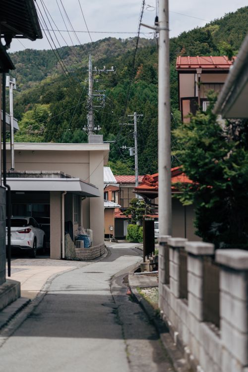 Free Charming street view in Yokosuka, Kanagawa, Japan with traditional houses and lush green hills. Stock Photo