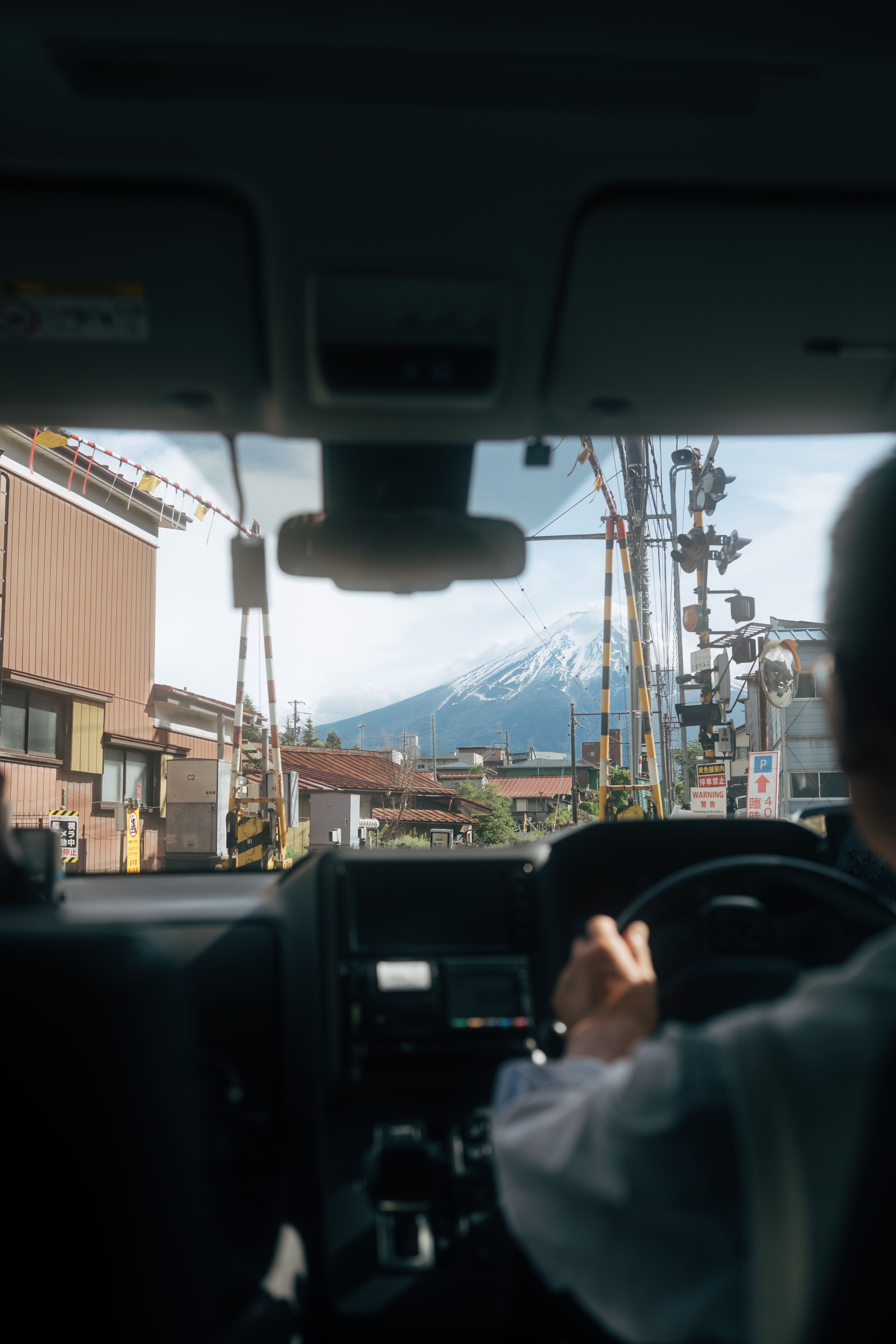 Free Driving view of Mount Fuji between buildings in Yokosuka, Japan, seen from inside a car. Stock Photo