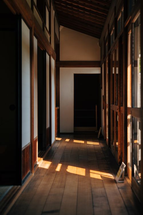 Free Warm light filters through a Japanese wooden corridor, creating a peaceful ambiance. Stock Photo