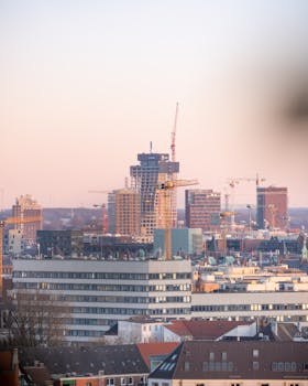 Sunset view of Hamburg skyline featuring modern urban construction.