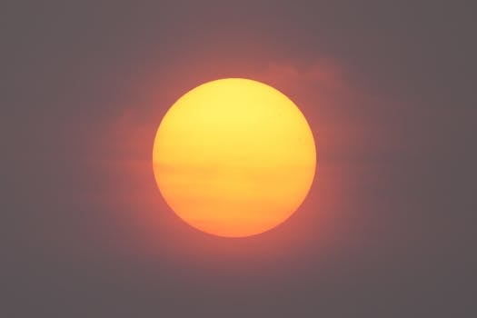 Vibrant sunrise in Stamford, Connecticut, filtered through wildfire haze creating a dramatic, warm glow.