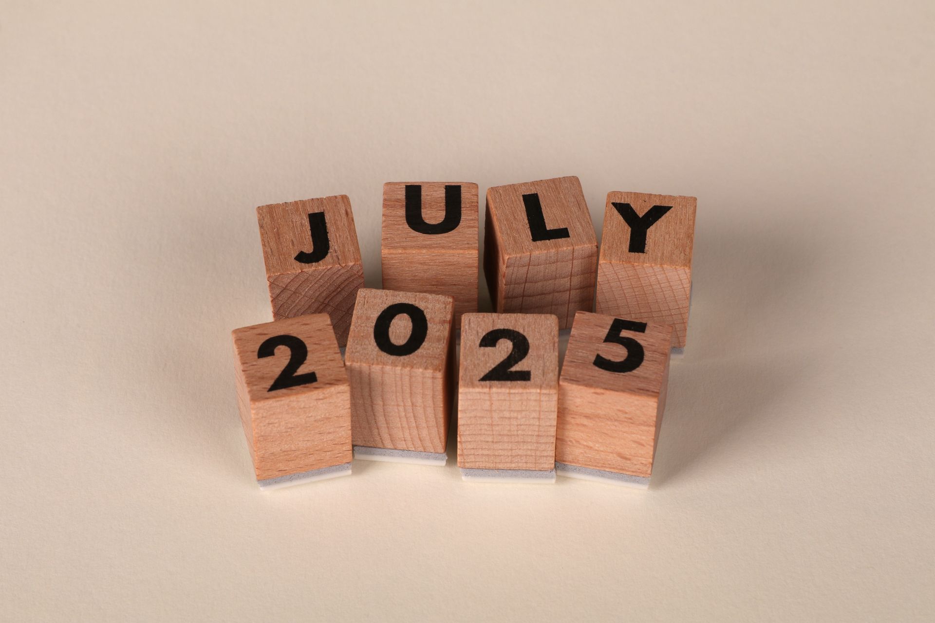 Wooden blocks arranged to show the date July 2025, perfect for calendar and planning themes.